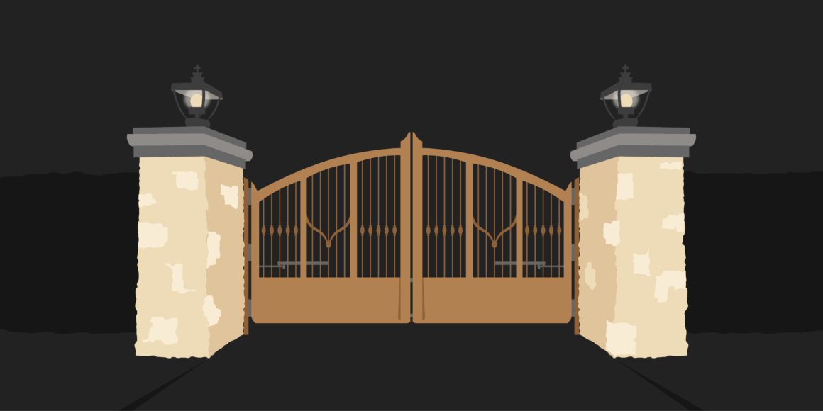 A tan concrete fence border with a brown wire closed fence. Two lanterns sit on either side of the fence.