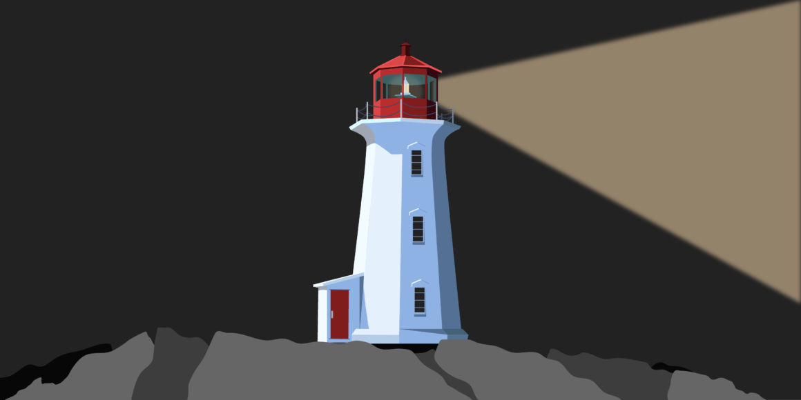 A white lighthouse on gray rocks in the dark. The top portion of the lighthouse is red and there is a beam of light coming out.